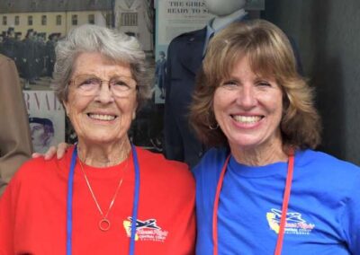 Veteran and her daughter guardian smiling together at the camera during an Honor Flight trip.
