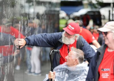Veteran and guardian at the etched mural wall at the Korean War Veterans Memorial.