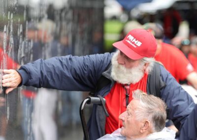 Veteran and guardian at the etched mural wall at the Korean War Veterans Memorial.