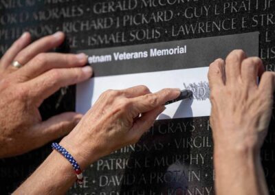 Veterans making a name rubbing at the Vietnam Veterans Memorial Wall in Washington, D.C.